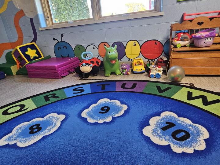 Colorful learning rug and toys at A Million Dreamz