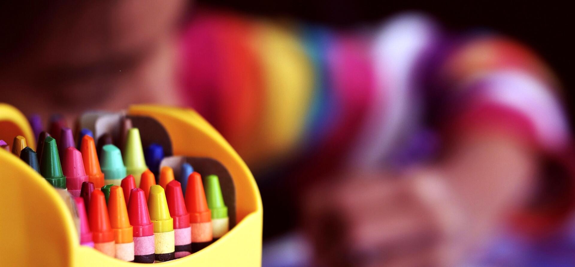 A child coloring with crayons at A Million Dreamz