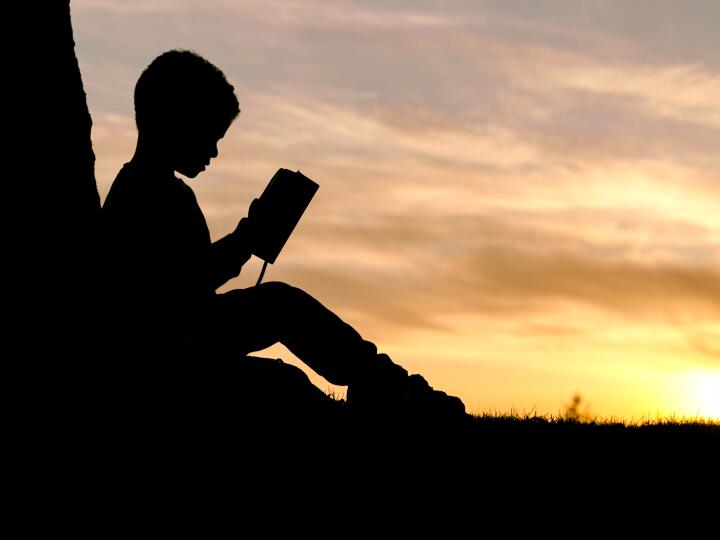 A child reading in an early childhood classroom